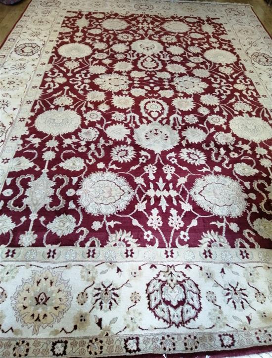 An Agra red ground carpet 410 x 290cm